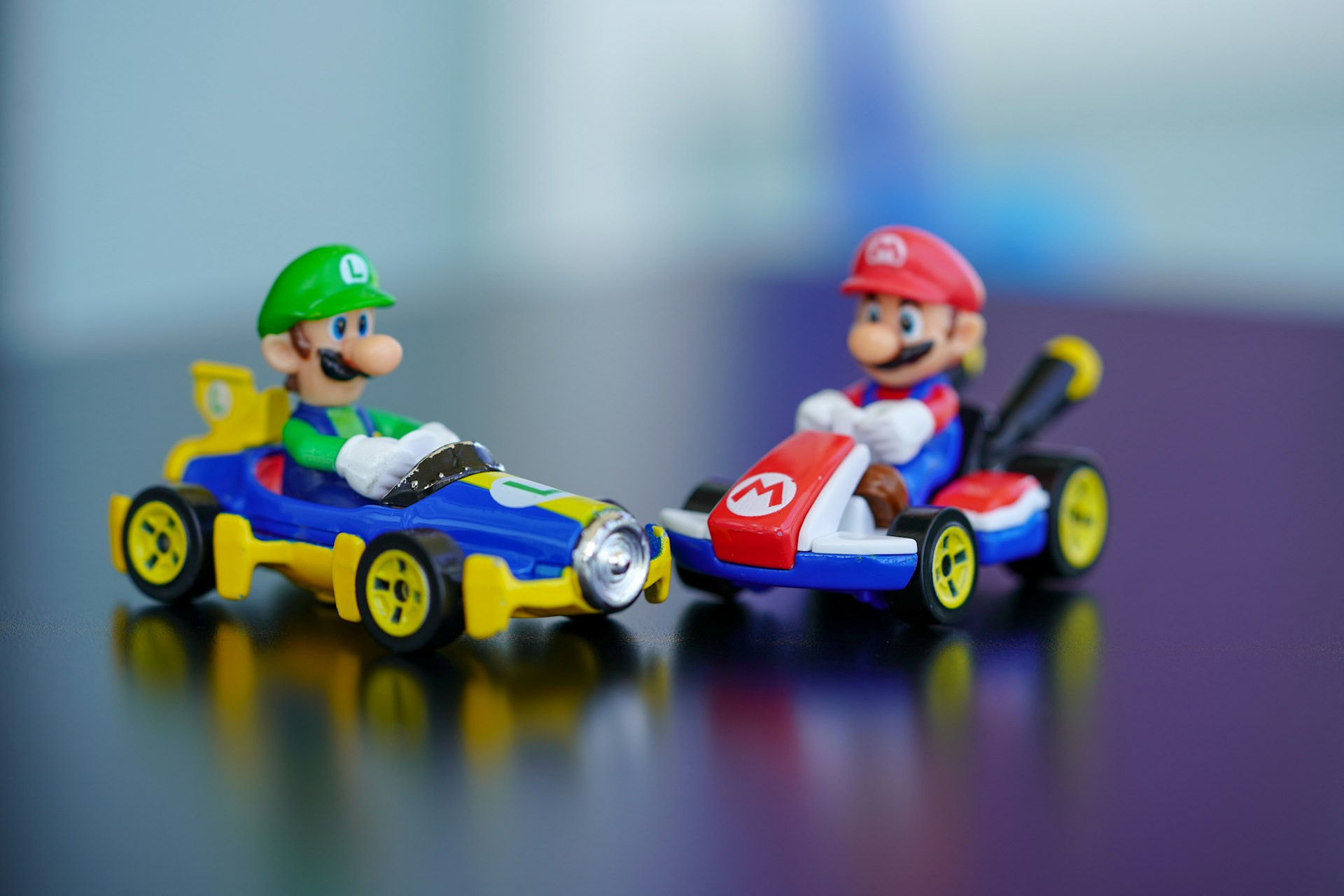 man in red helmet riding orange and blue f 1 car toy